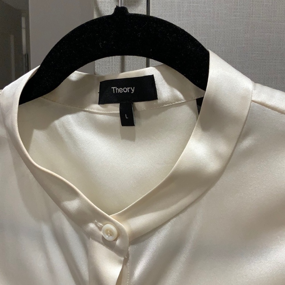 Beautiful ivory SILK, sleeveless blouse is stunning. Never been worn, no tags.